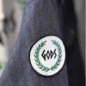 GODS embroidered patch on a denim jacket sleeve